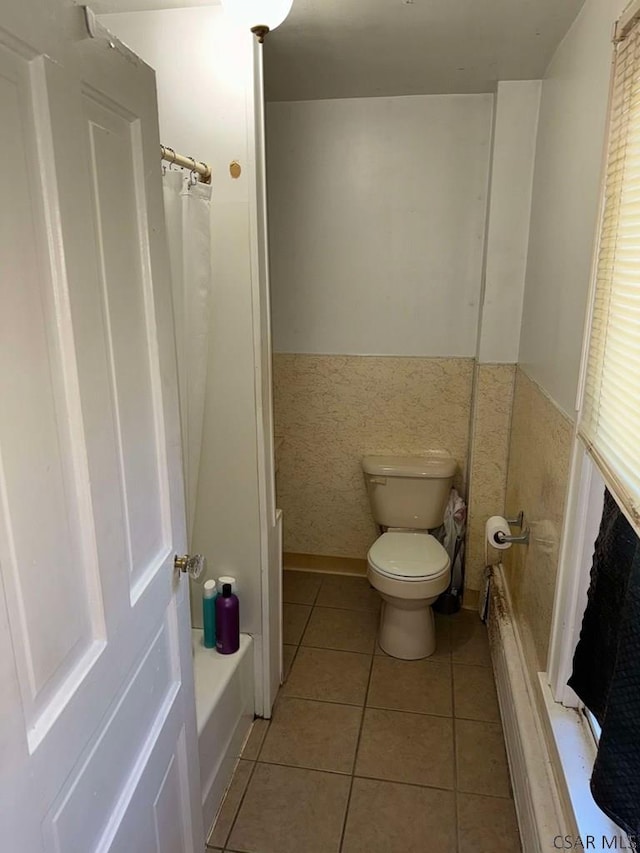 bathroom with tile patterned floors and toilet