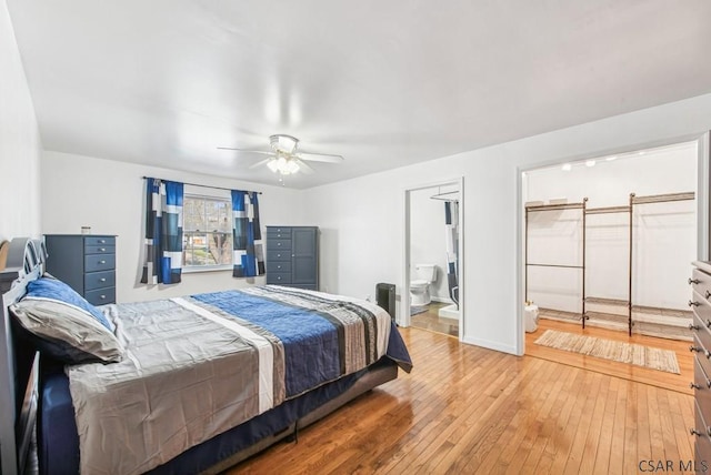 bedroom featuring ensuite bath, light hardwood / wood-style flooring, and ceiling fan