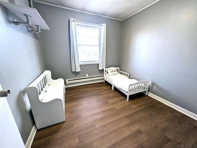 bedroom with ornamental molding, baseboard heating, wood finished floors, and baseboards