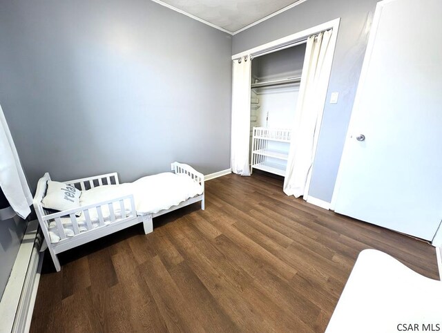 miscellaneous room with ornamental molding and dark hardwood / wood-style floors