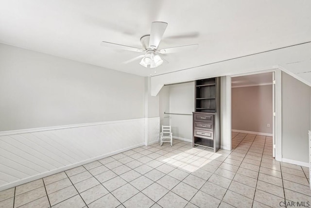 unfurnished bedroom with light tile patterned floors, ceiling fan, and a closet