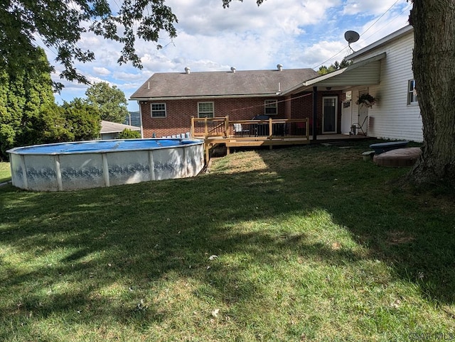 outdoor pool with a deck and a lawn