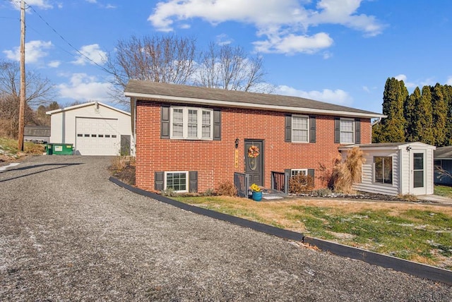 split foyer home with a garage and an outdoor structure