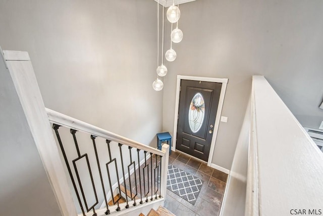 entrance foyer with stairs and baseboards