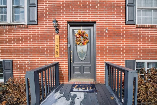 property entrance featuring brick siding