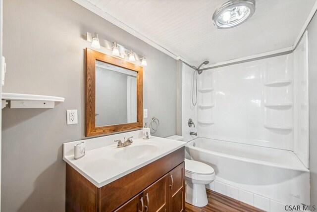 full bathroom with toilet, shower / bathing tub combination, ornamental molding, vanity, and hardwood / wood-style floors