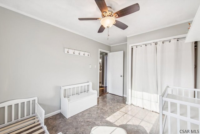 unfurnished bedroom with baseboards, ornamental molding, and a ceiling fan