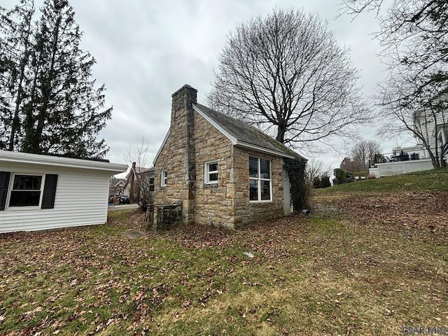 view of home's exterior with a lawn