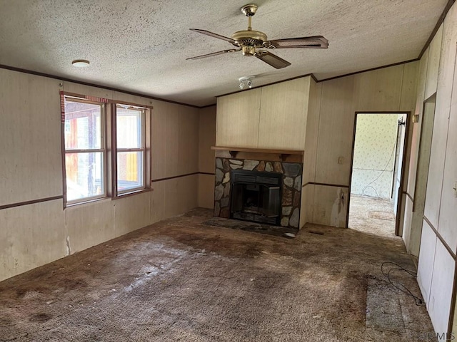 unfurnished living room featuring a stone fireplace, a textured ceiling, and carpet flooring