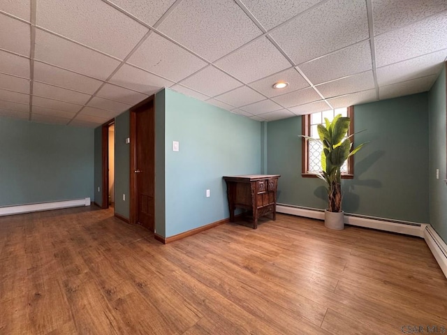 unfurnished room featuring a drop ceiling and wood-type flooring