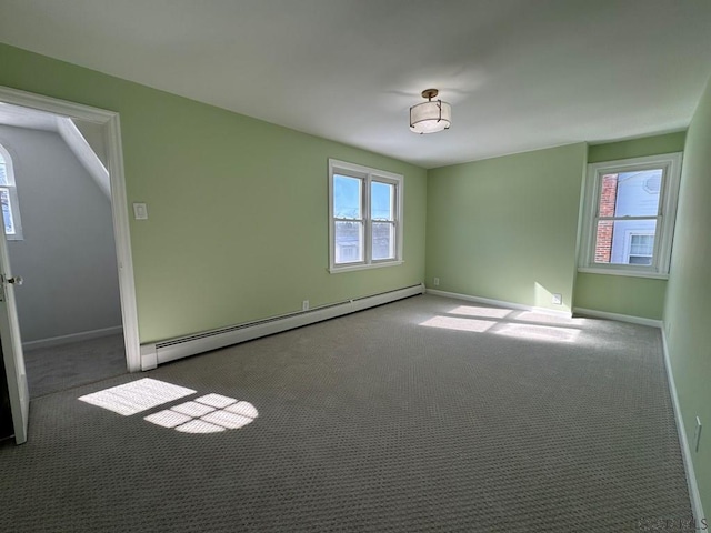 unfurnished room with carpet and baseboard heating