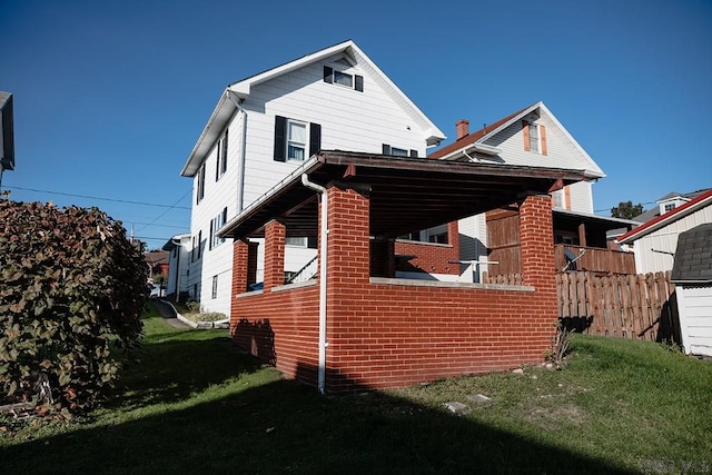 rear view of property with a yard