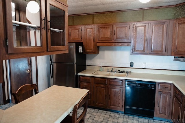 kitchen featuring stainless steel refrigerator, crown molding, black dishwasher, and sink