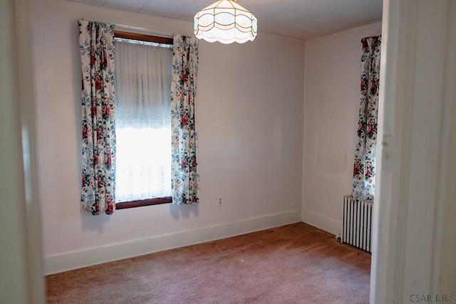 carpeted empty room with radiator heating unit