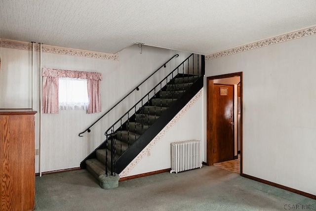 stairs featuring radiator heating unit, a textured ceiling, and carpet flooring