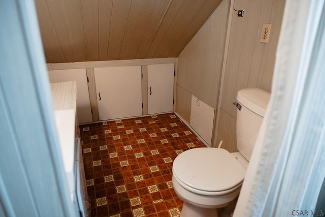 bathroom with wooden ceiling, toilet, and wood walls