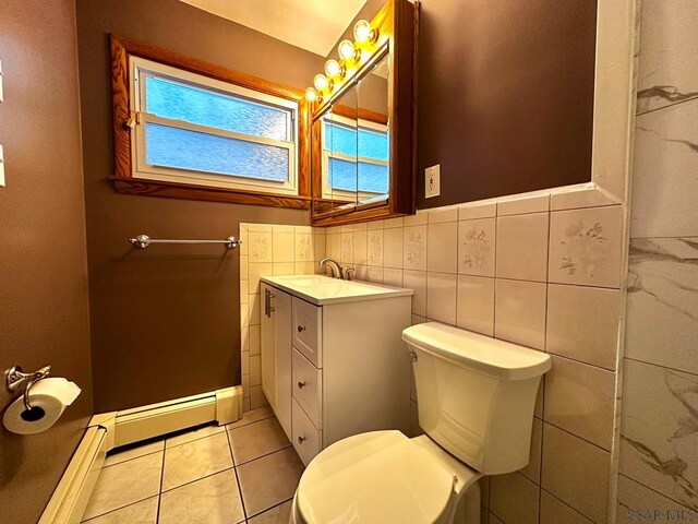 bathroom featuring tile patterned floors, toilet, tile walls, a baseboard radiator, and vanity