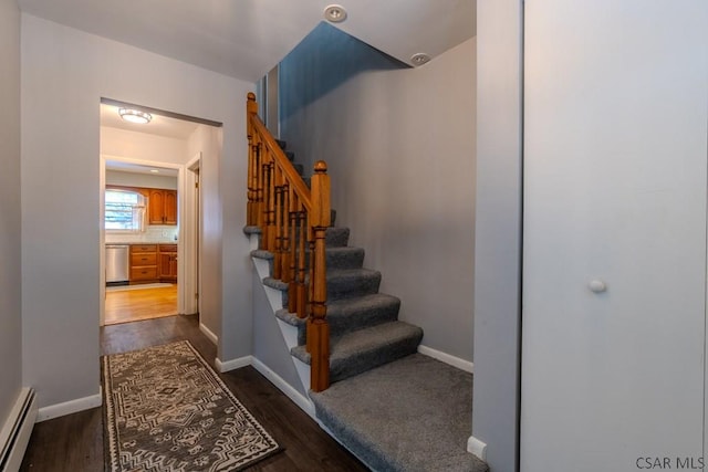 stairs with hardwood / wood-style flooring and baseboard heating