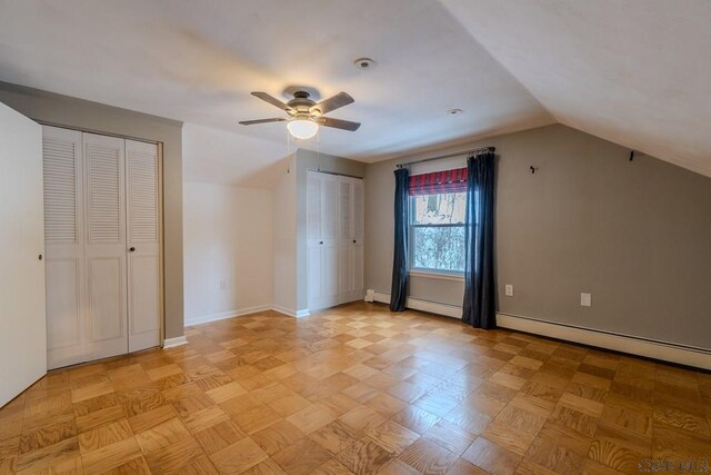 bonus room featuring light parquet floors, lofted ceiling, a baseboard heating unit, and ceiling fan