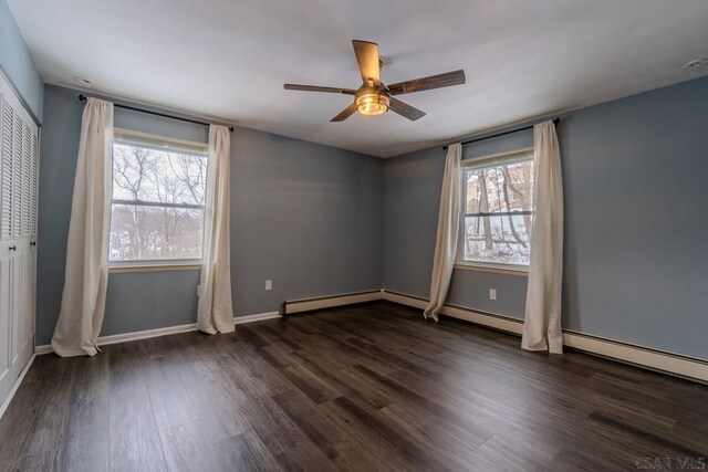 empty room featuring ceiling fan and dark hardwood / wood-style flooring