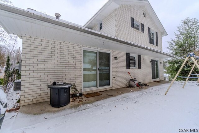 view of snow covered rear of property