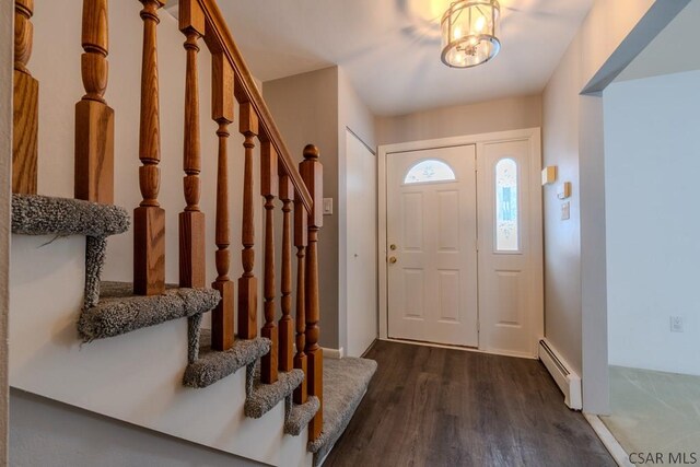 foyer with dark hardwood / wood-style floors and a baseboard heating unit