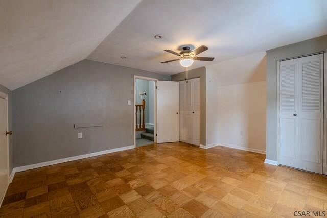 bonus room featuring ceiling fan, vaulted ceiling, and light parquet floors