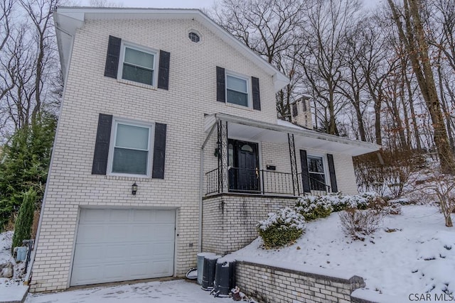 view of front of house with a garage and central air condition unit