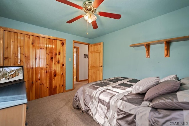 carpeted bedroom featuring ceiling fan and a closet