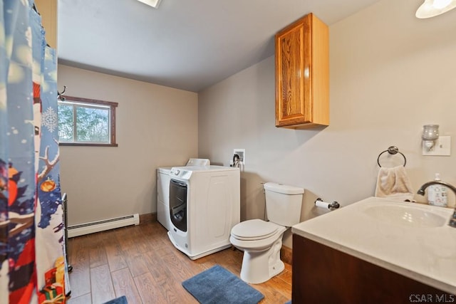 laundry area with hardwood / wood-style floors, sink, a baseboard heating unit, and washer hookup