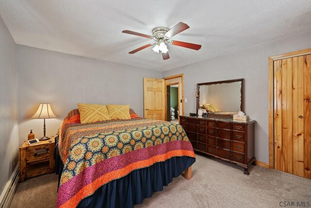 bedroom with a textured ceiling, light colored carpet, ceiling fan, and baseboard heating