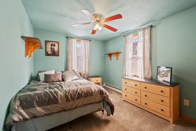 bedroom featuring ceiling fan, a baseboard radiator, multiple windows, and a textured ceiling