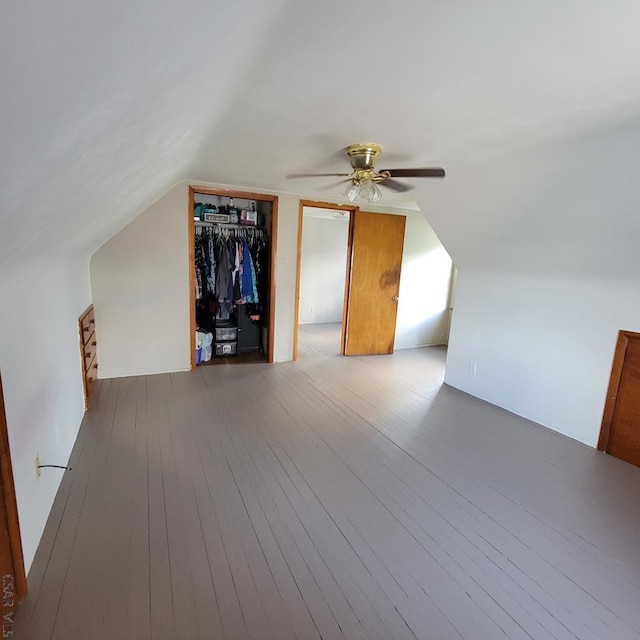 bonus room with hardwood / wood-style flooring and vaulted ceiling