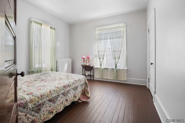 bedroom featuring dark wood-type flooring and radiator heating unit