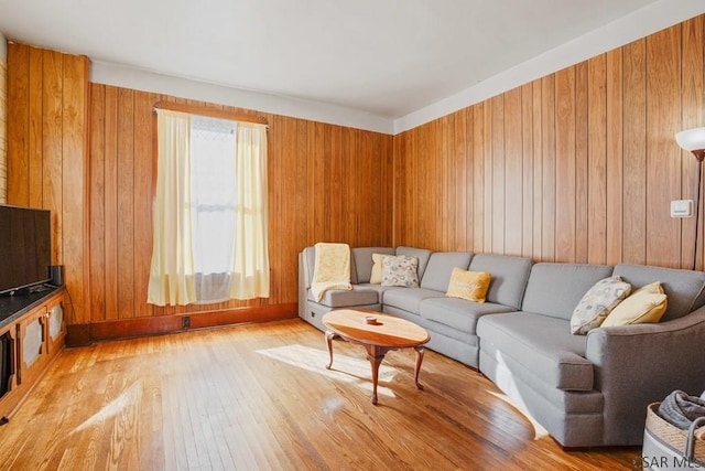 living room featuring wood-type flooring and wood walls