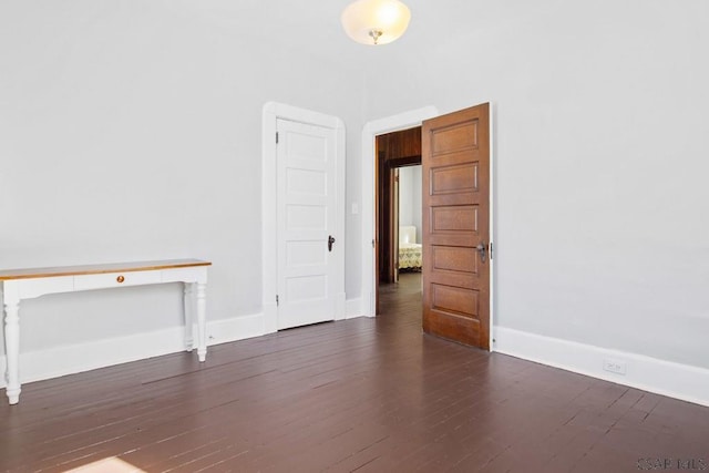 empty room featuring dark wood-type flooring