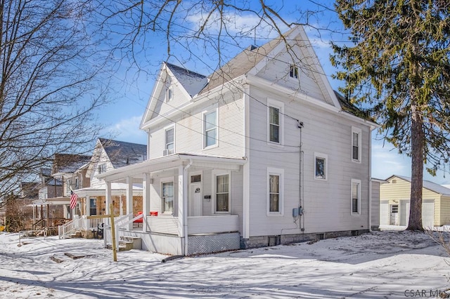 view of snow covered exterior with a porch