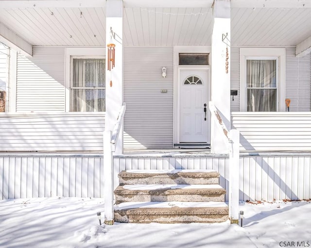 view of snow covered property entrance