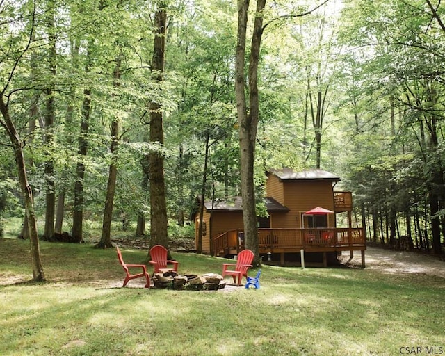 view of yard with an outdoor fire pit and a deck