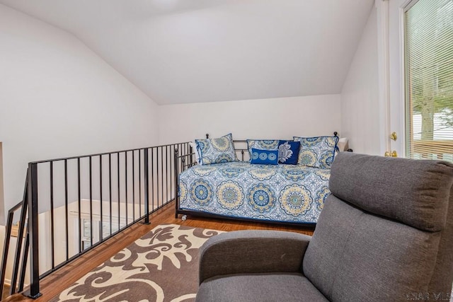 bedroom featuring lofted ceiling and wood finished floors