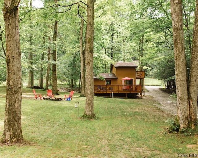 view of yard featuring a fire pit and a wooden deck