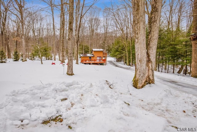 yard layered in snow with a wooden deck