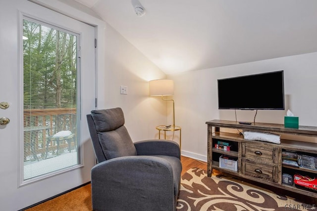 living area with light wood-style flooring, baseboards, and vaulted ceiling