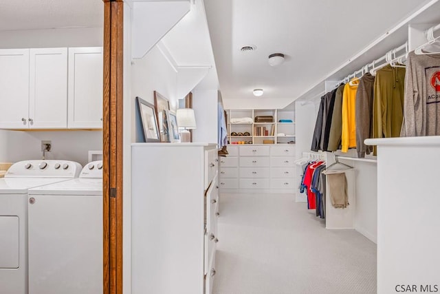 clothes washing area with cabinet space, visible vents, independent washer and dryer, and light carpet