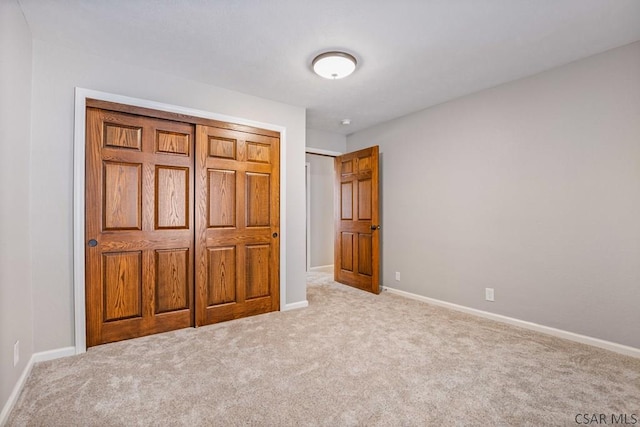 unfurnished bedroom featuring carpet flooring and baseboards