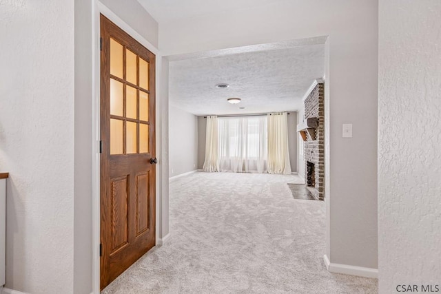 corridor with baseboards, a textured ceiling, a textured wall, and carpet floors