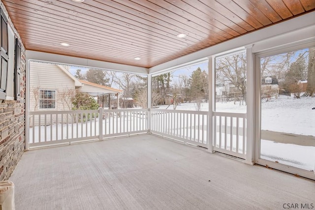 unfurnished sunroom with a healthy amount of sunlight and wood ceiling