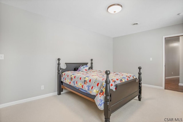 carpeted bedroom featuring visible vents and baseboards