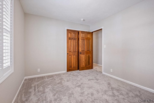 unfurnished bedroom featuring baseboards and carpet floors