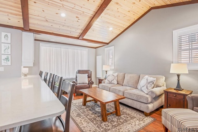 living area with wooden ceiling, vaulted ceiling with beams, and light wood finished floors